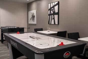 A table with a hockey puck on it in a room with other tables and chairs